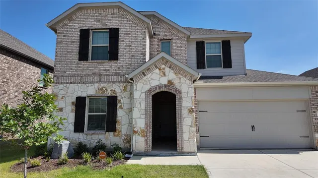 a front view of a house with yard