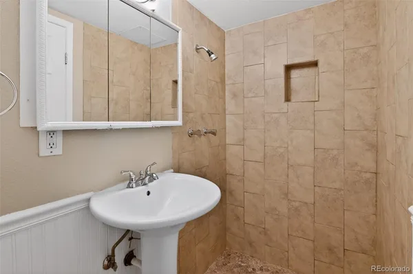 a bathroom with a sink a mirror and shower