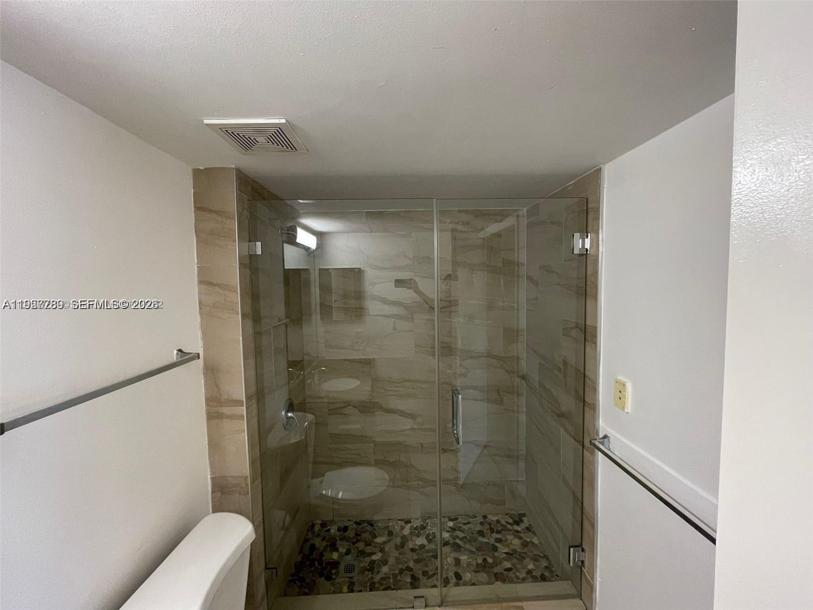 761 North Pine Island Road, Unit 104 Plantation, FL 33324 - Photo 11 of 15 a bathroom with a shower and toilet