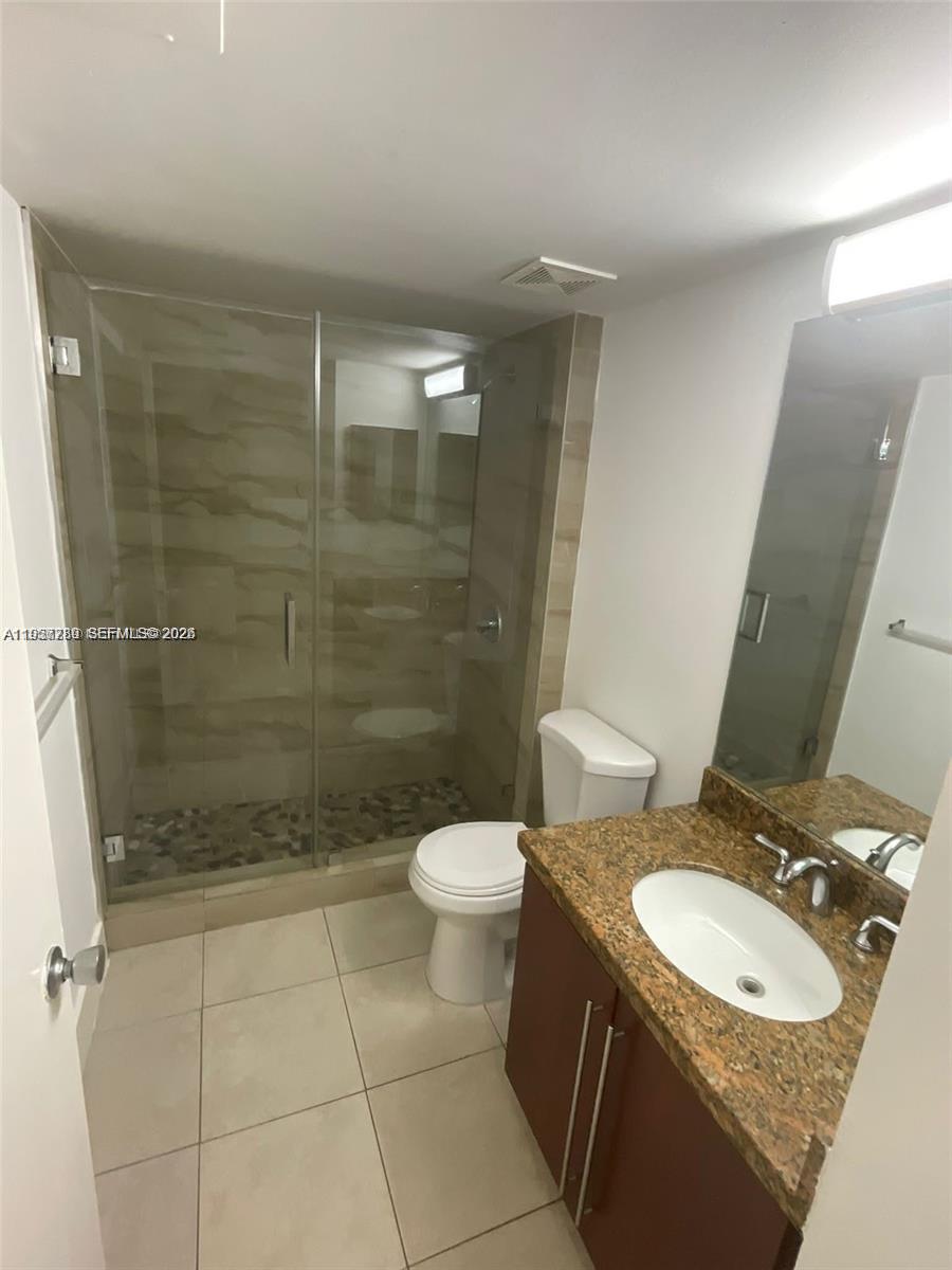 761 North Pine Island Road, Unit 104 Plantation, FL 33324 - Photo 12 of 15 a bathroom with a granite countertop sink toilet and shower