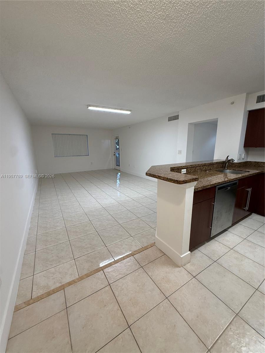 761 North Pine Island Road, Unit 104 Plantation, FL 33324 - Photo 16 of 26 a kitchen with stainless steel appliances granite countertop a sink and a stove