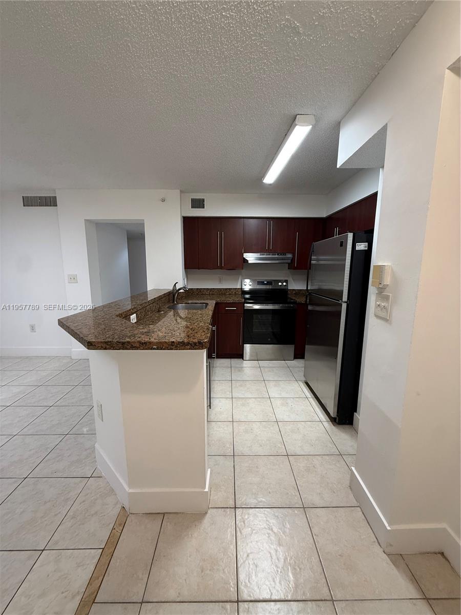 761 North Pine Island Road, Unit 104 Plantation, FL 33324 - Photo 17 of 26 a kitchen with a sink and cabinets
