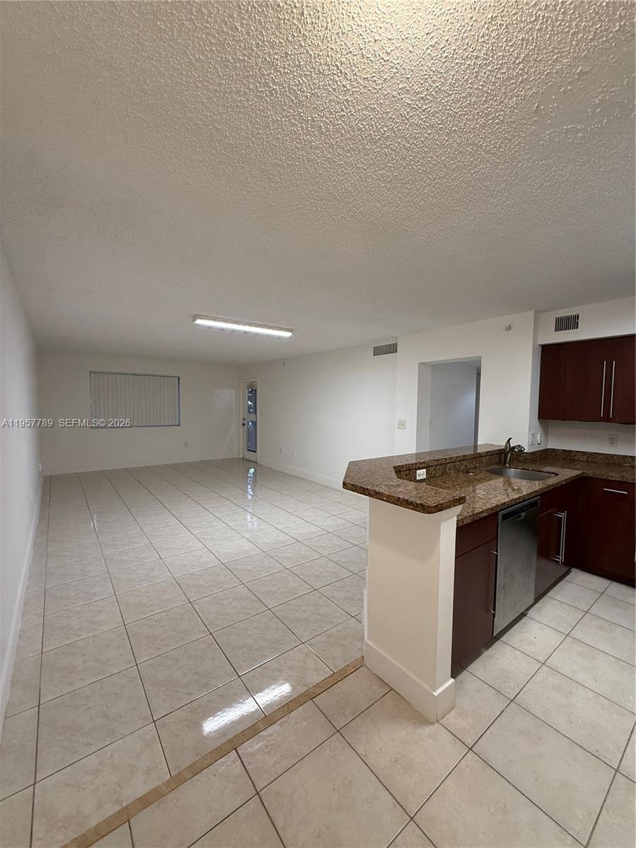 761 North Pine Island Road, Unit 104 Plantation, FL 33324 - Photo 19 of 26 a kitchen with stainless steel appliances granite countertop a sink and a stove