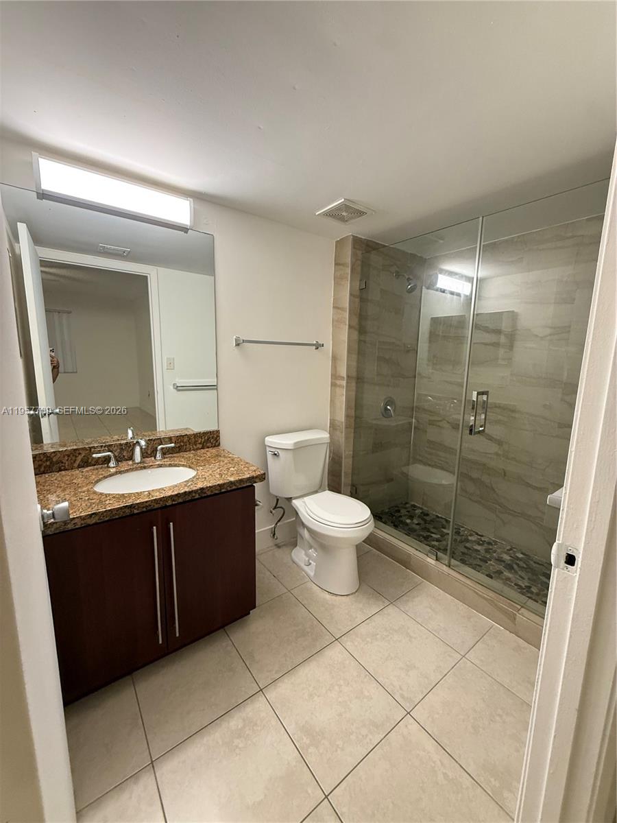 761 North Pine Island Road, Unit 104 Plantation, FL 33324 - Photo 21 of 26 a bathroom with a sink a toilet a mirror and shower