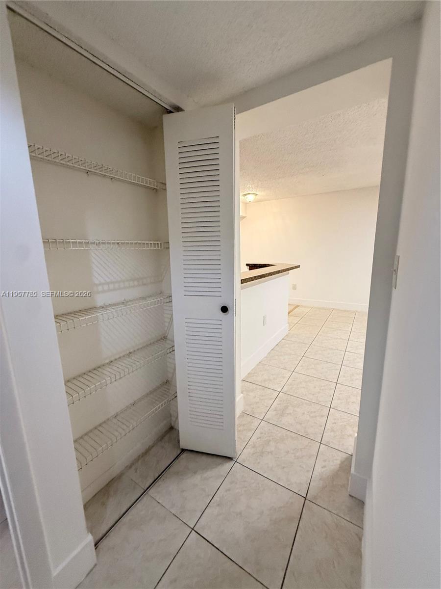 761 North Pine Island Road, Unit 104 Plantation, FL 33324 - Photo 25 of 26 a view of walk in closet with empty racks