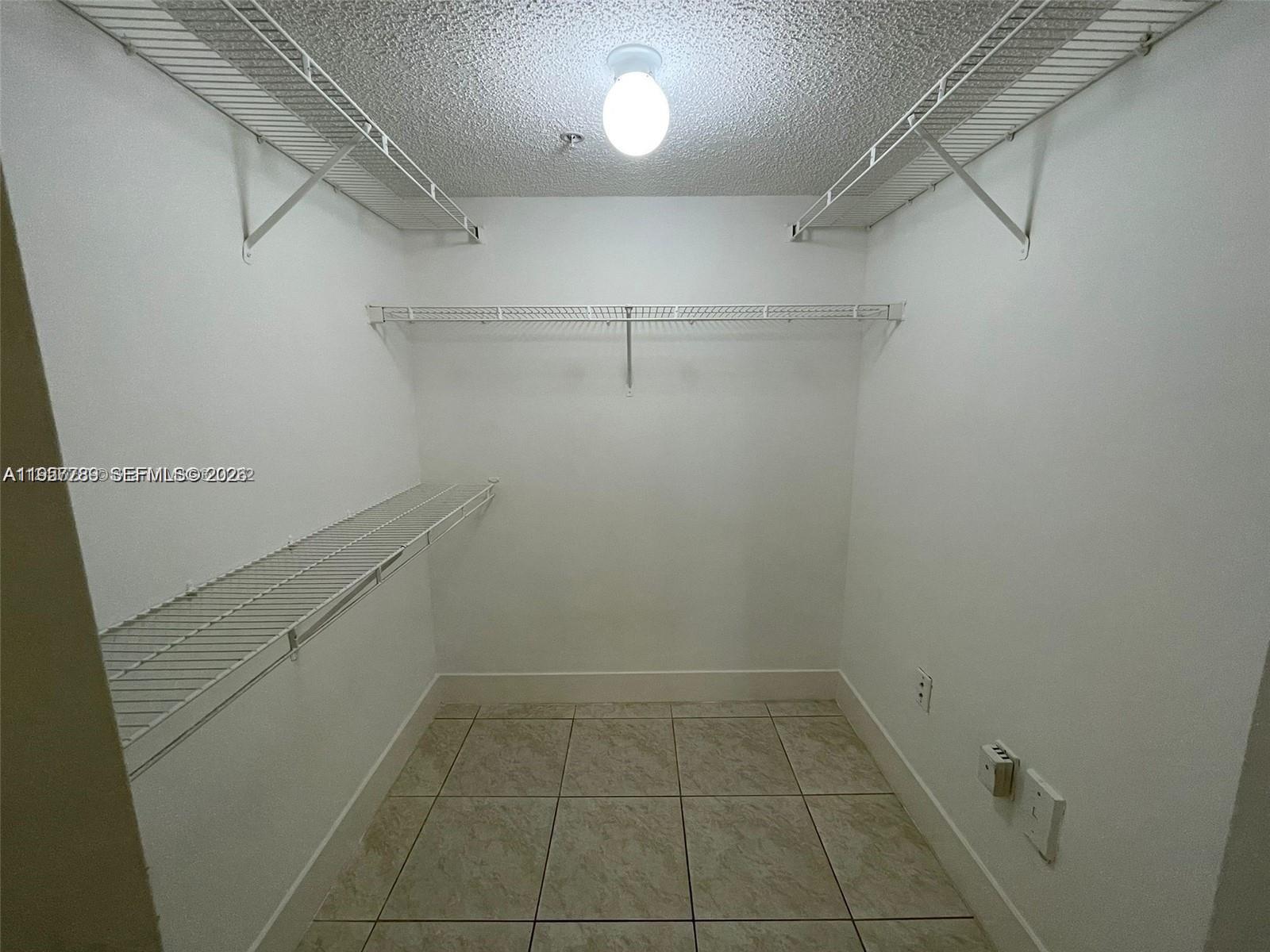 761 North Pine Island Road, Unit 104 Plantation, FL 33324 - Photo 4 of 15 a view of a room with racks on the wall