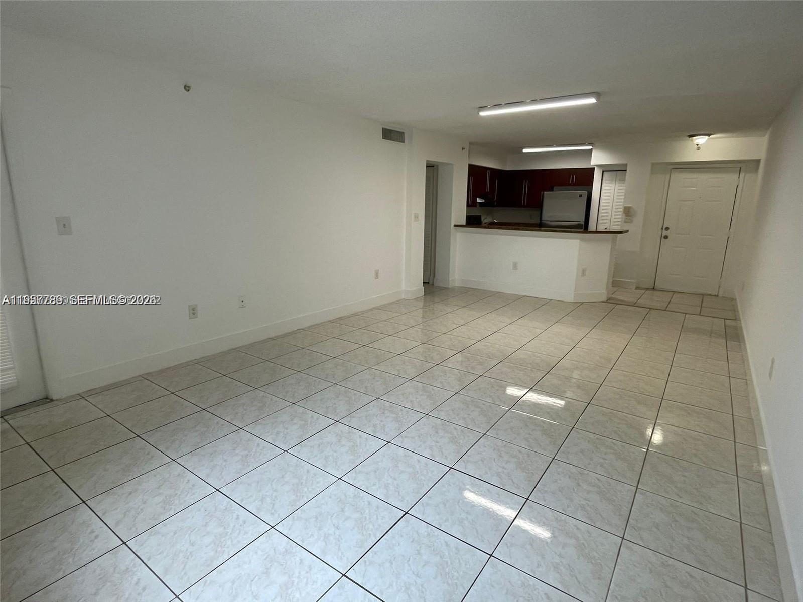 761 North Pine Island Road, Unit 104 Plantation, FL 33324 - Photo 5 of 15 a view of a kitchen with a sink and a microwave