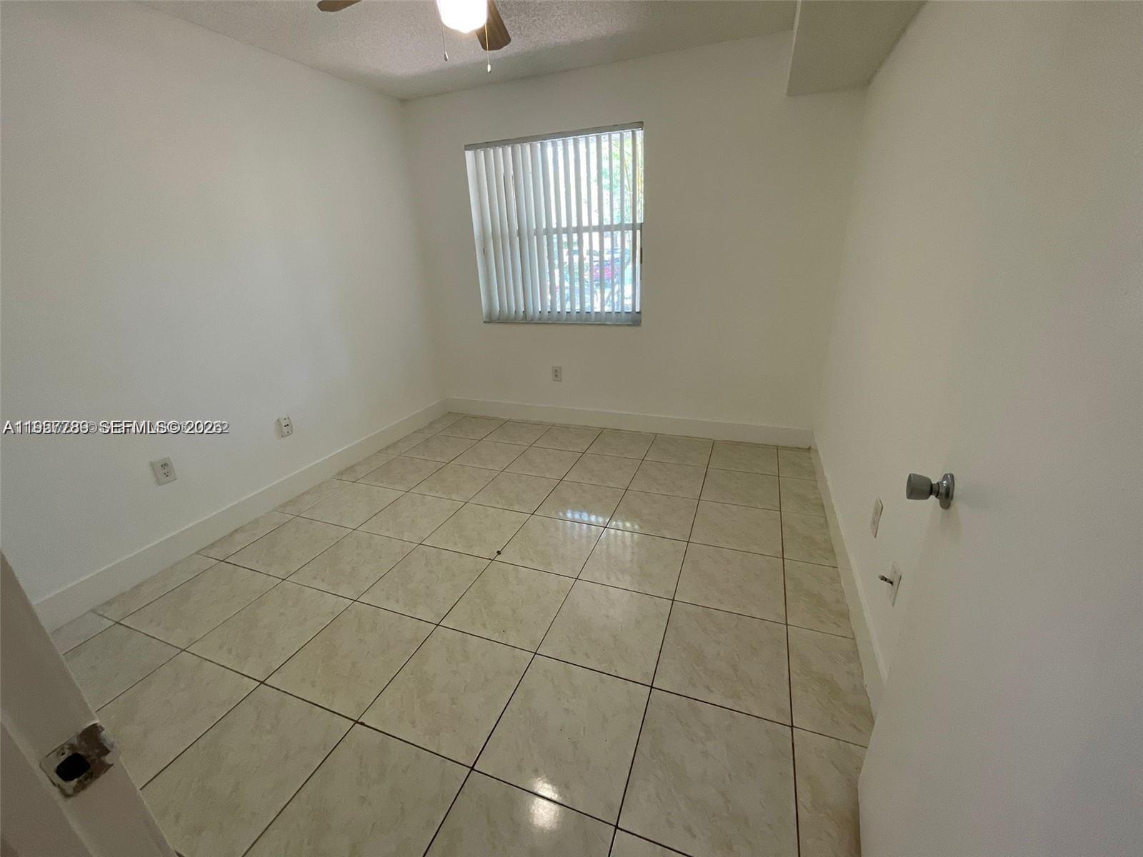 761 North Pine Island Road, Unit 104 Plantation, FL 33324 - Photo 6 of 15 a view of an empty room with a window