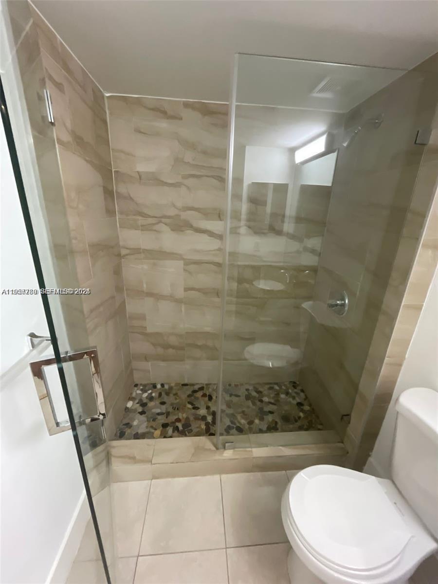 761 North Pine Island Road, Unit 104 Plantation, FL 33324 - Photo 10 of 15 a bathroom with a shower and toilet