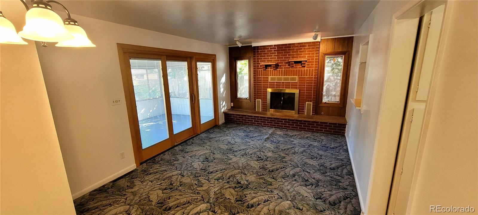 3450 Benton Street Wheat Ridge, CO 80212 - Photo 8 of 20 a view of a porch with wooden floor and a door