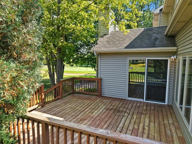 a backyard of a house with barbeque oven and trees