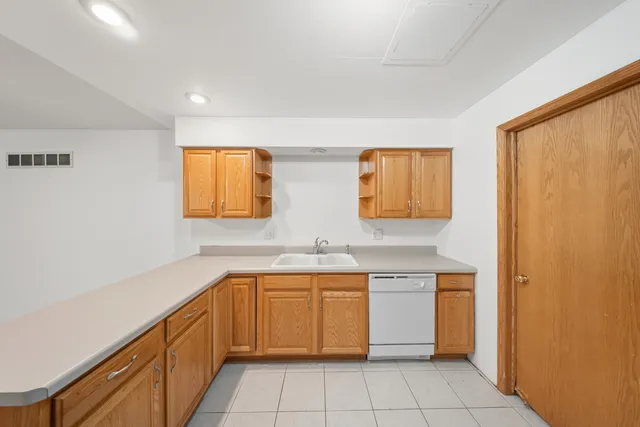 a kitchen with a sink stove and cabinets