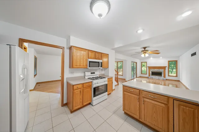 a kitchen with granite countertop a sink and white cabinets