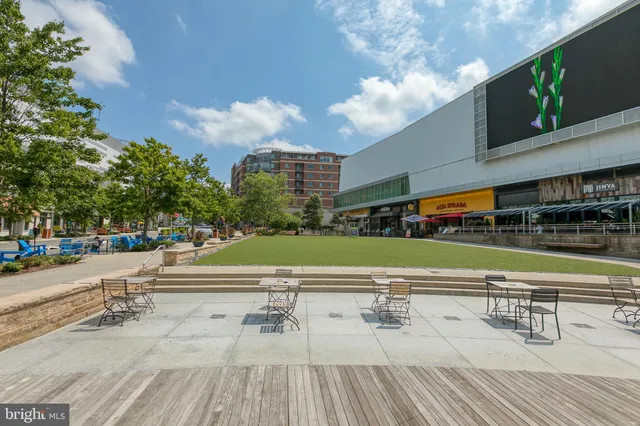a view of a swimming pool with outdoor seating and plants