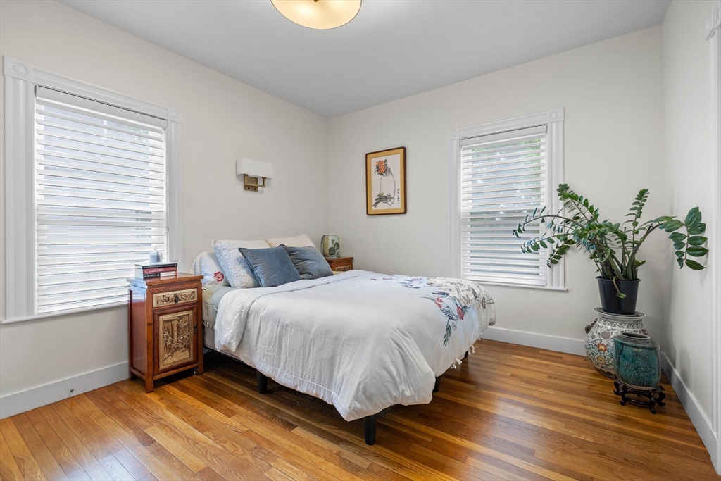 228 Langley Road Newton, MA 02459 - Photo 14 of 39 a bedroom with a bed and wooden floor