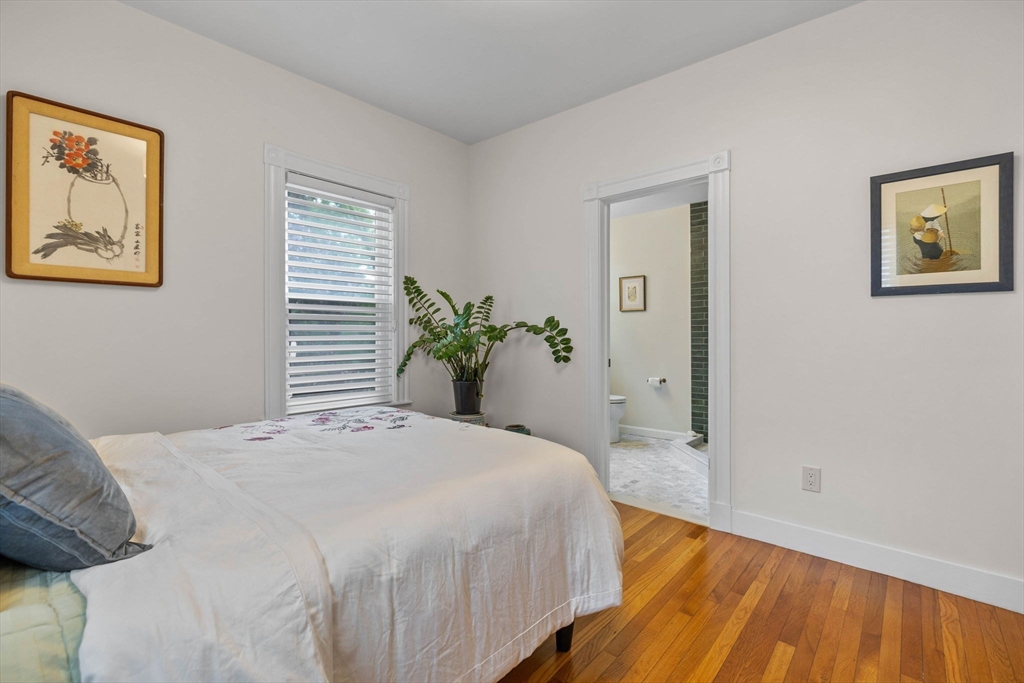 228 Langley Road Newton, MA 02459 - Photo 15 of 39 a bedroom with a bed and wooden floor