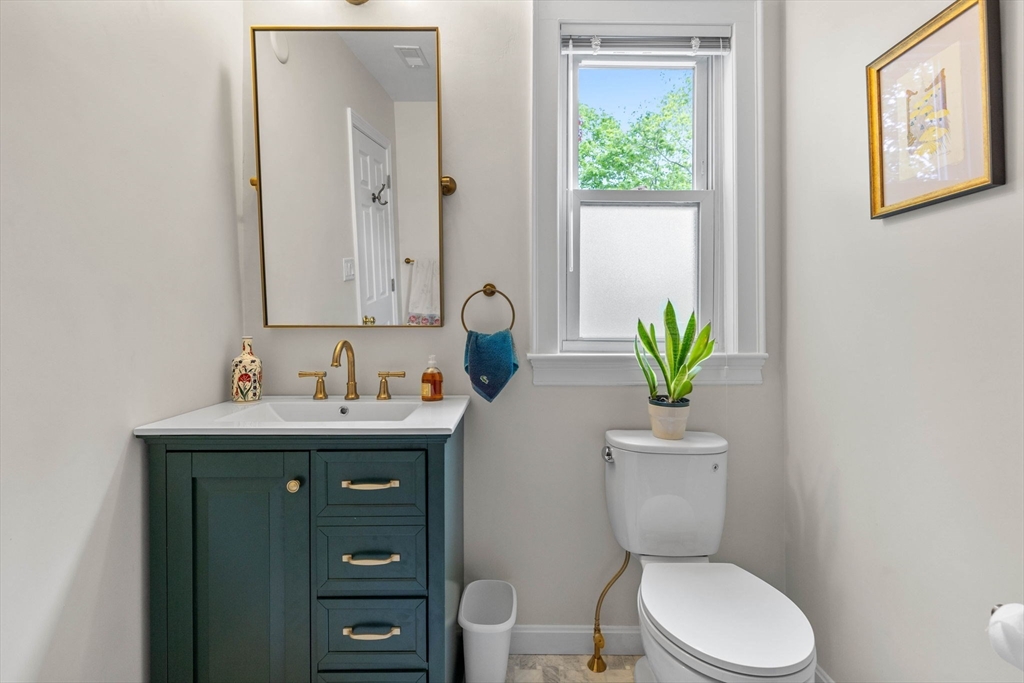228 Langley Road Newton, MA 02459 - Photo 16 of 39 a bathroom with a toilet a sink and mirror