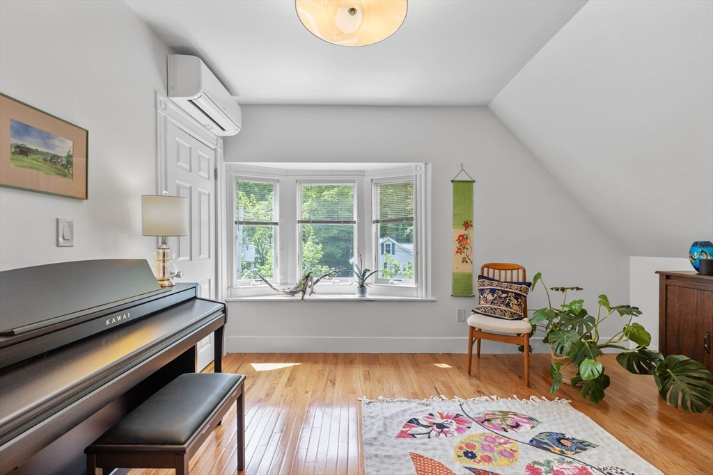 228 Langley Road Newton, MA 02459 - Photo 23 of 39 a living room with furniture and a potted plant