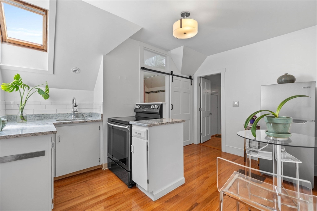 228 Langley Road Newton, MA 02459 - Photo 26 of 39 a kitchen with a refrigerator and a sink