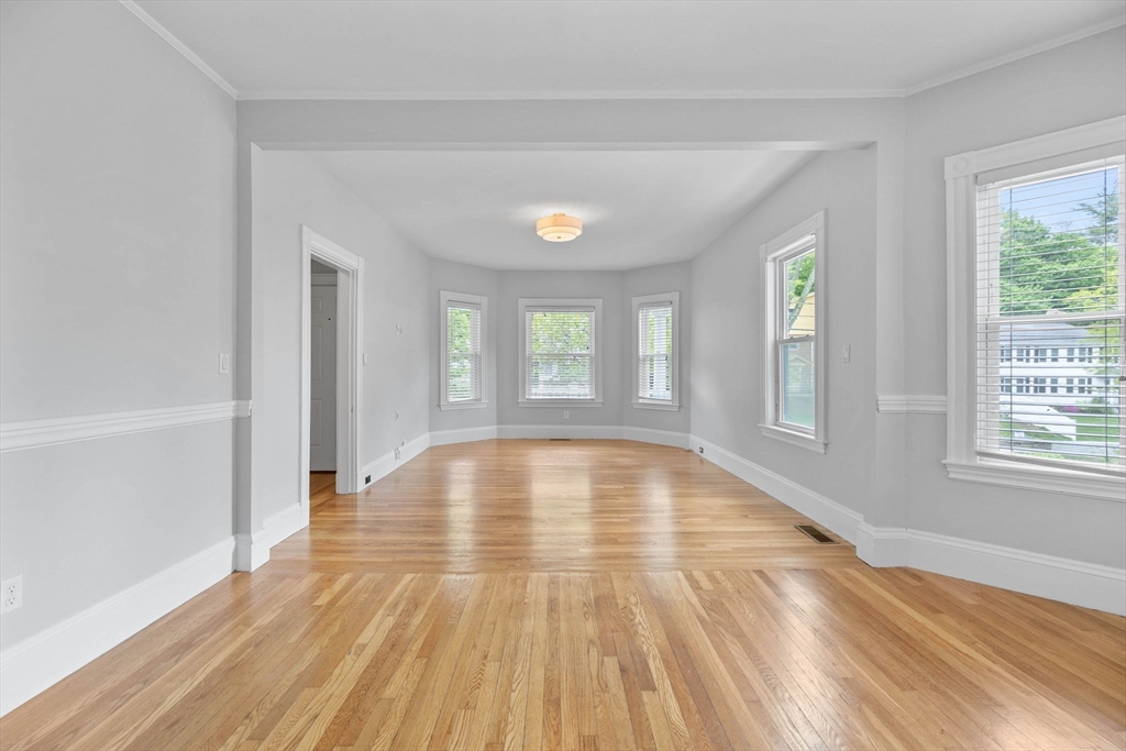 228 Langley Road Newton, MA 02459 - Photo 3 of 39 a view of empty room with wooden floor and fan