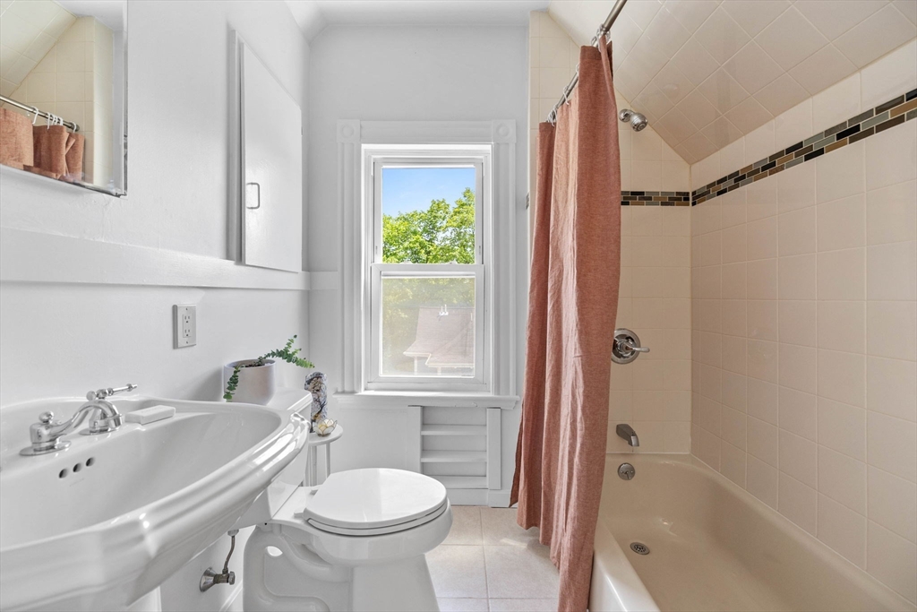 228 Langley Road Newton, MA 02459 - Photo 31 of 39 a bathroom with a sink toilet and shower