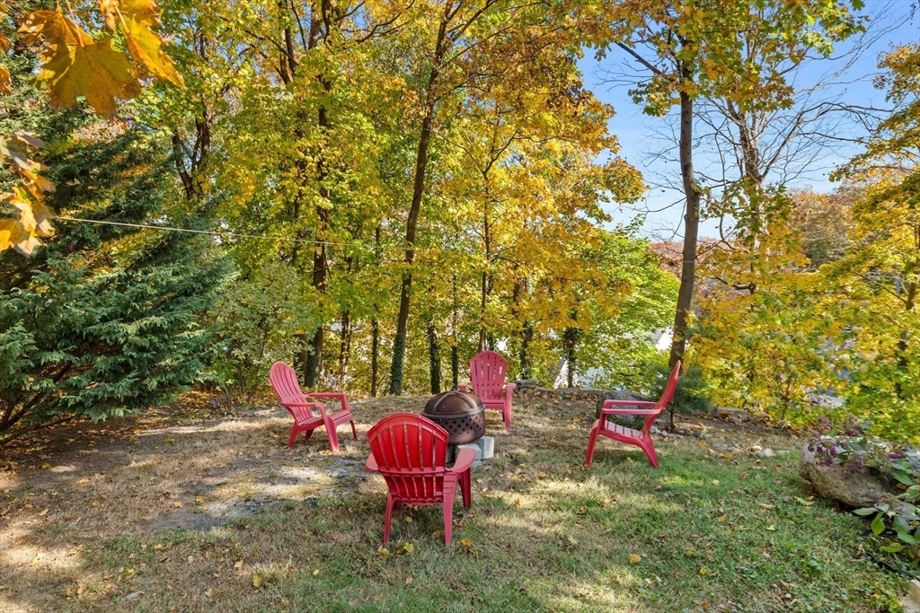 228 Langley Road Newton, MA 02459 - Photo 36 of 39 a backyard with table and chairs