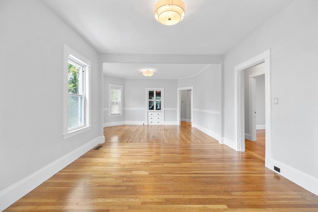 228 Langley Road Newton, MA 02459 - Photo 4 of 39 a view of empty room with wooden floor and fan