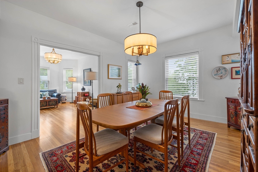228 Langley Road Newton, MA 02459 - Photo 9 of 39 a view of a dining room with furniture window and wooden floor