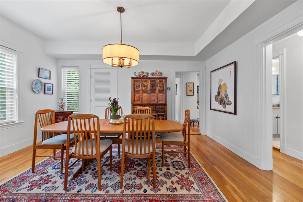 228 Langley Road Newton, MA 02459 - Photo 10 of 39 a view of a dining room with furniture wooden floor and a chandelier