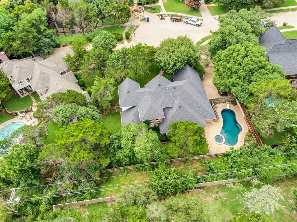 1907 Timber Ridge Court Cedar Hill, TX 75104 - Photo 30 of 30 Expansive property featuring a multi-level roofline, mature trees, a curvilinear swimming pool, and an integrated spa