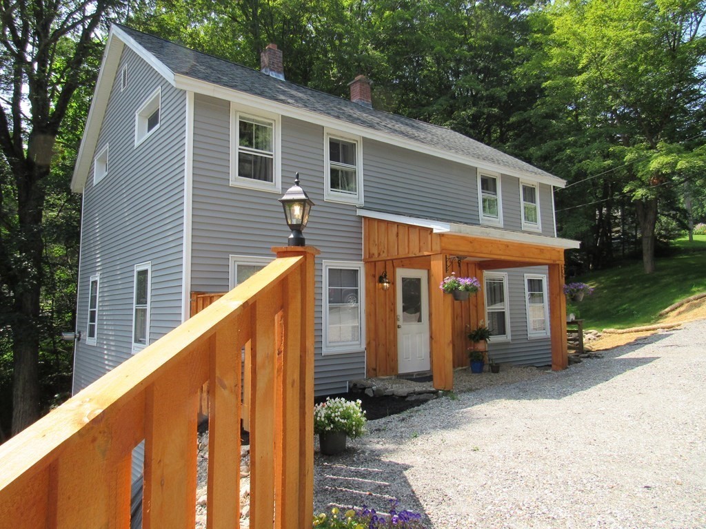 18 Blandford Hill Road Huntington, MA 01050 - Photo 1 of 33 a view of a house with backyard and sitting area