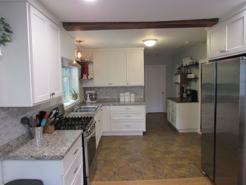 18 Blandford Hill Road Huntington, MA 01050 - Photo 12 of 33 a kitchen with stainless steel appliances granite countertop a sink stove and refrigerator