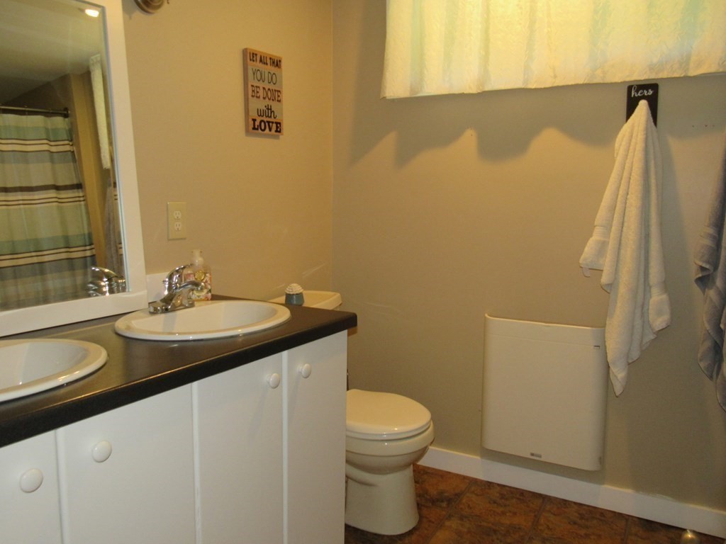 18 Blandford Hill Road Huntington, MA 01050 - Photo 21 of 33 a bathroom with a granite countertop sink toilet and a mirror