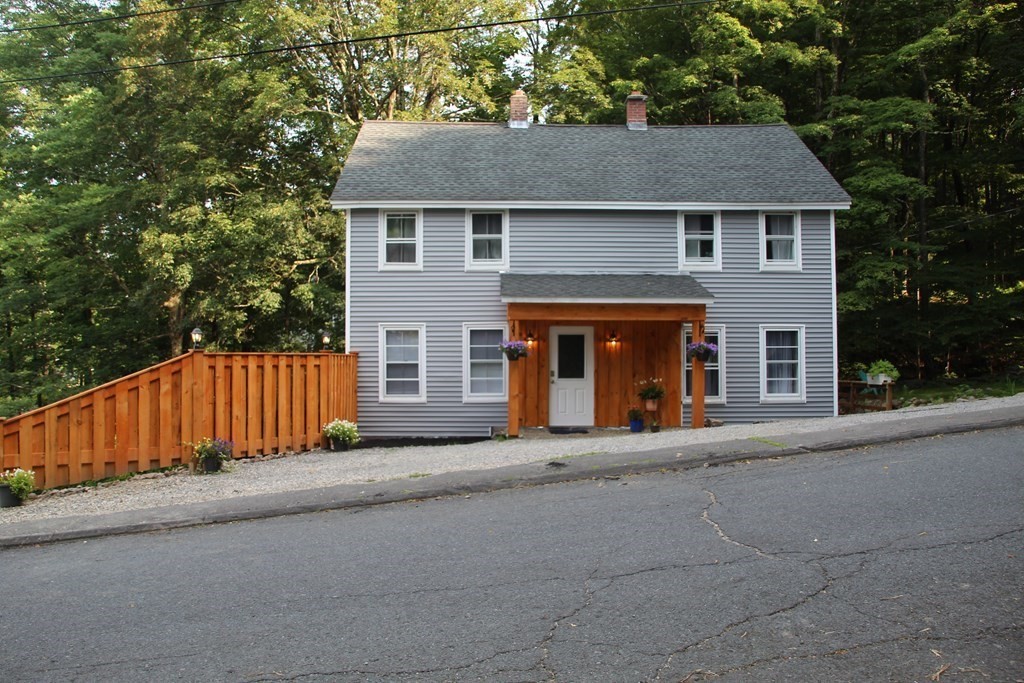 18 Blandford Hill Road Huntington, MA 01050 - Photo 3 of 33 a front view of a house with a yard and garage