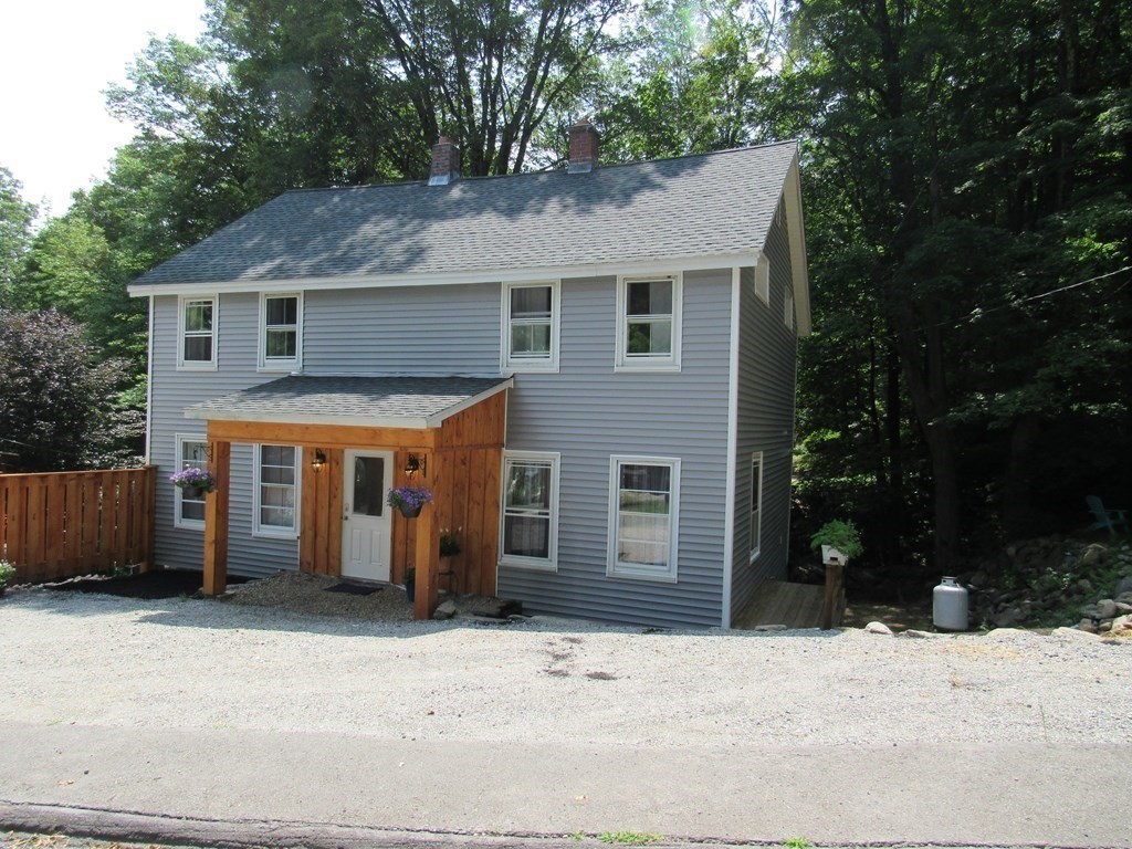 18 Blandford Hill Road Huntington, MA 01050 - Photo 33 of 33 a front view of a house with a yard and garage