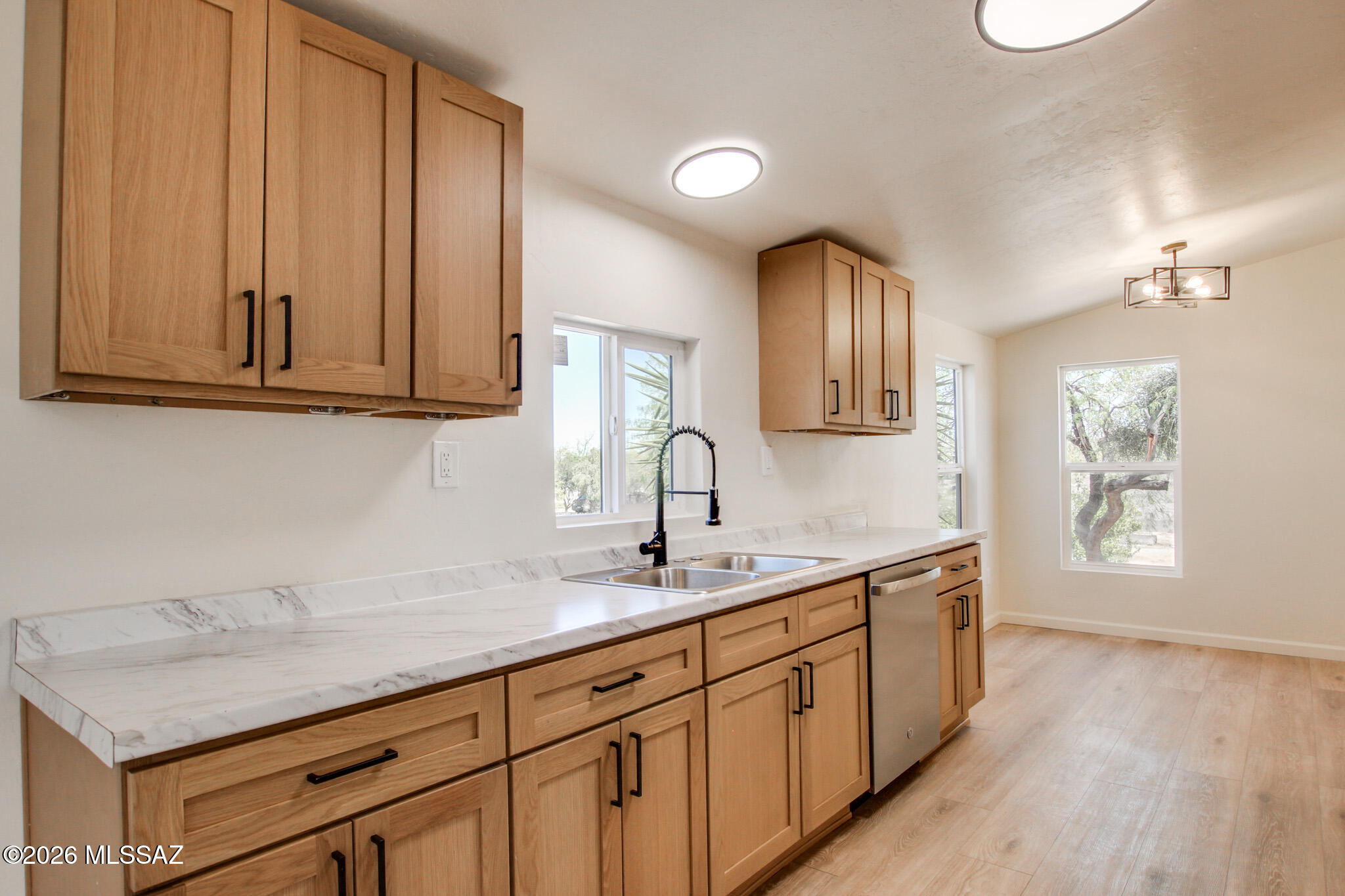 14303 West Rolina Lane Tucson, AZ 85736 - Photo 2 of 38 a kitchen with granite countertop white cabinets and sink