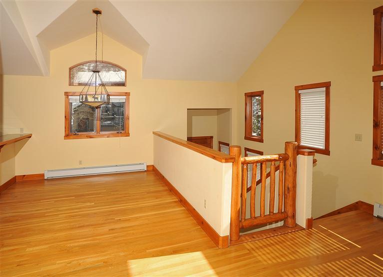 83 Knudson Ranch Road Edwards, CO 81632 - Photo 5 of 21 a view of a room with wooden floor staircase and a chandelier