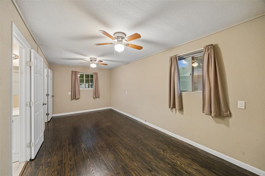 117 Moon Street Cleburne, TX 76033 - Photo 16 of 28 wooden floor in an empty room with a window