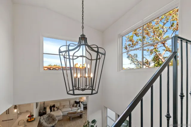 a backyard of a house with table and chairs under an umbrella