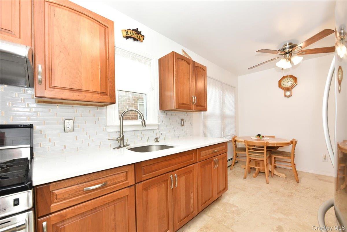 19 Sprague Drive Valley Stream, NY 11580 - Photo 13 of 30 a kitchen with a sink and cabinets