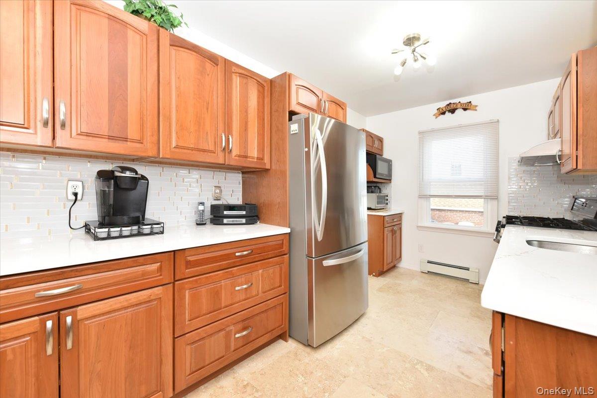 19 Sprague Drive Valley Stream, NY 11580 - Photo 14 of 30 a kitchen with stainless steel appliances a refrigerator sink and cabinets