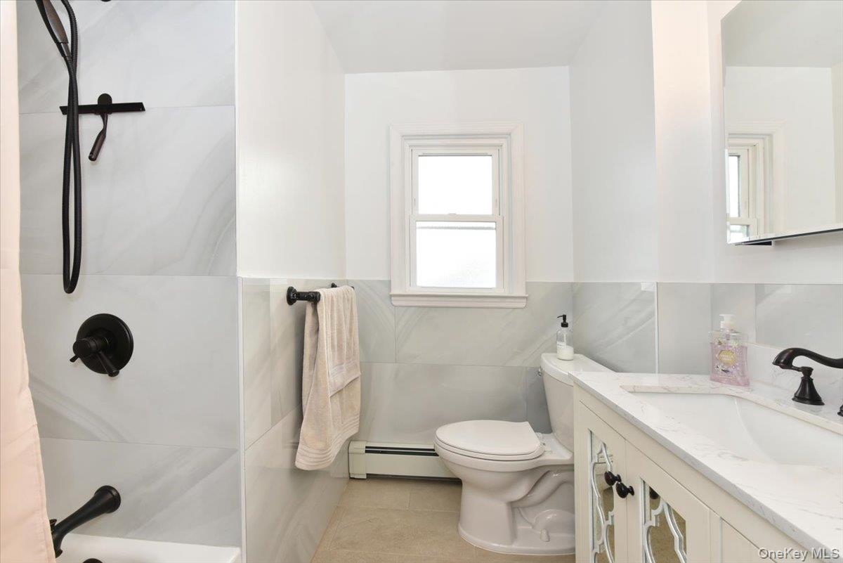 19 Sprague Drive Valley Stream, NY 11580 - Photo 18 of 30 a bathroom with a sink a toilet and a shower