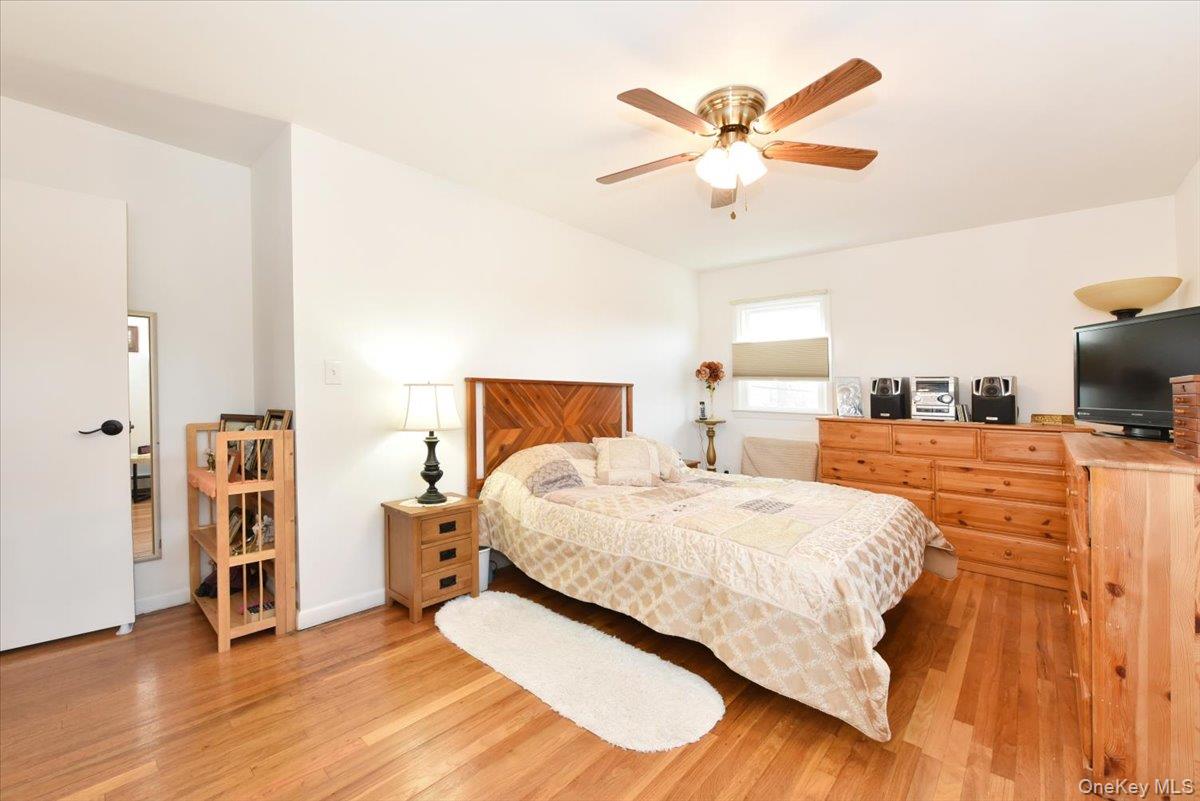 19 Sprague Drive Valley Stream, NY 11580 - Photo 21 of 30 a bedroom with a bed and a ceiling fan