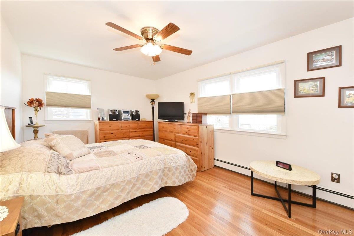 19 Sprague Drive Valley Stream, NY 11580 - Photo 22 of 30 a bedroom with a bed and a chandelier
