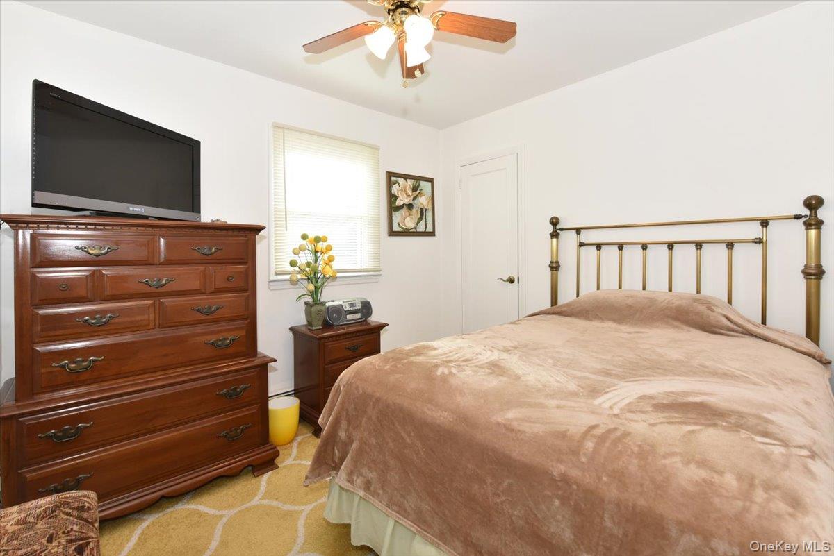 19 Sprague Drive Valley Stream, NY 11580 - Photo 23 of 30 a bedroom with a bed and a flat screen tv