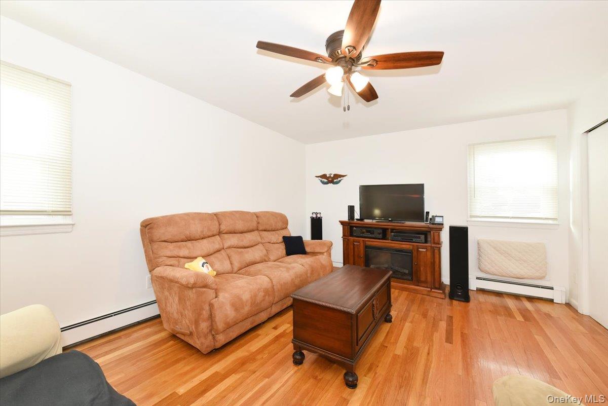 19 Sprague Drive Valley Stream, NY 11580 - Photo 25 of 30 a living room with furniture and a flat screen tv