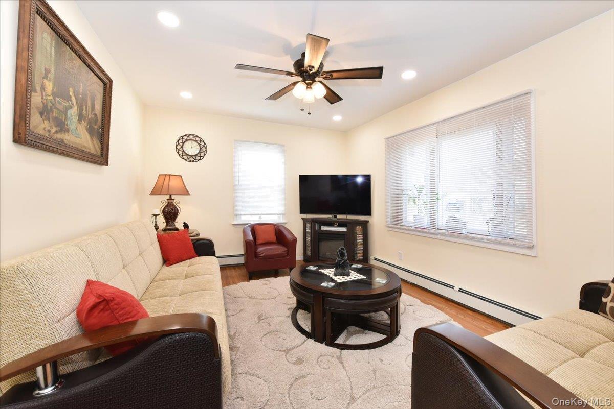 19 Sprague Drive Valley Stream, NY 11580 - Photo 6 of 30 a living room with furniture and a flat screen tv