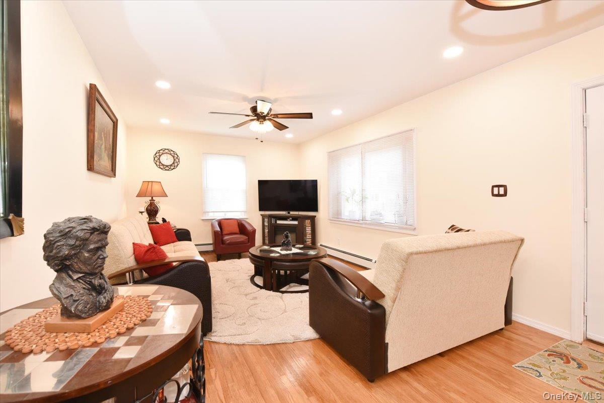 19 Sprague Drive Valley Stream, NY 11580 - Photo 7 of 30 a living room with furniture and a flat screen tv