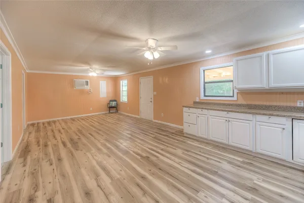 a view of empty room with window and ceiling fan