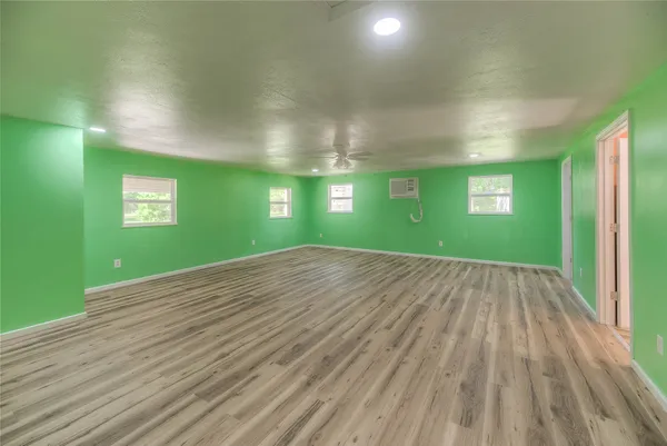 a view of empty room with window and stairs